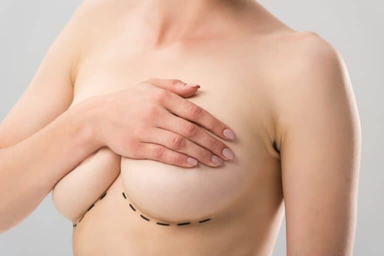 naked woman covering her breasts