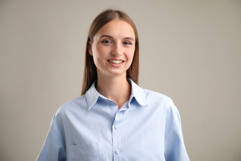 young woman smiling wearing blue shirt