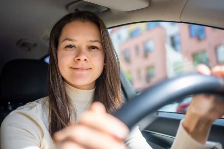smiling woman driving car